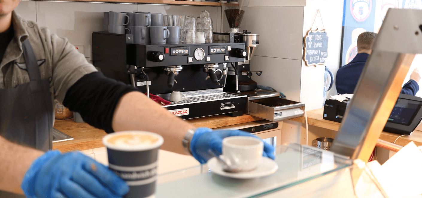 cafe serving latte and espresso from coffee machine